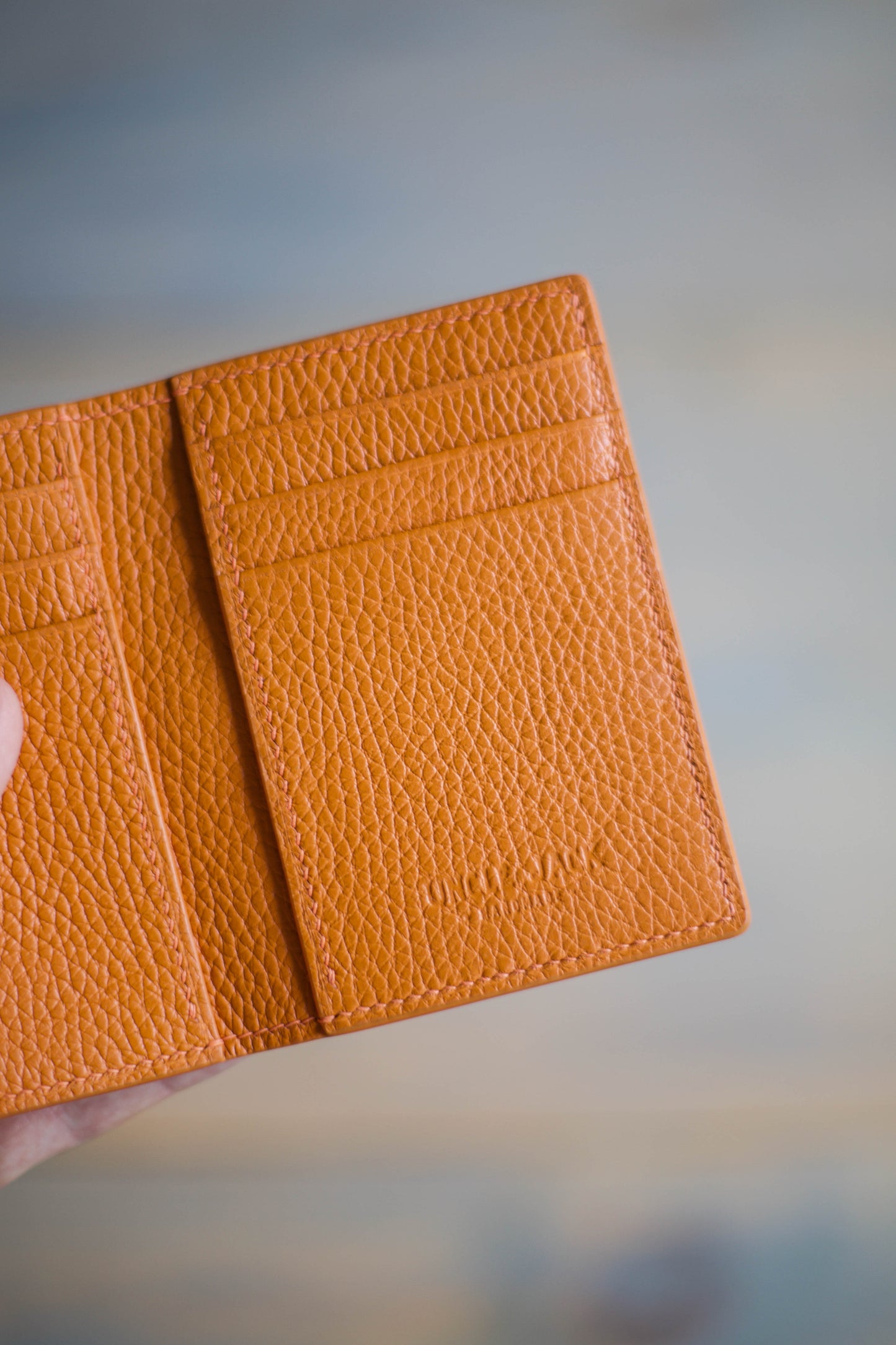 6 SLOT BIFOLD (orange pebbled leather)